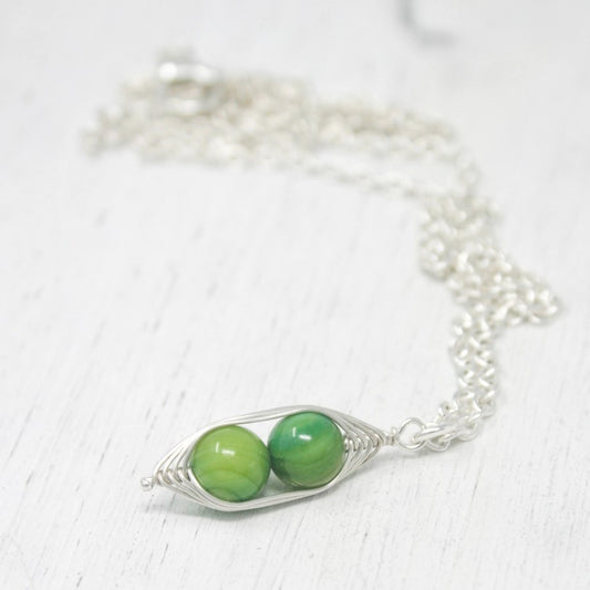 2 green beads attached together by silver wires necklace