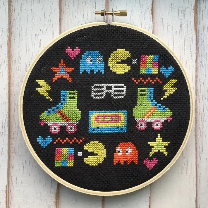 pac-man, roller skates and various 80s symbols cross stitch