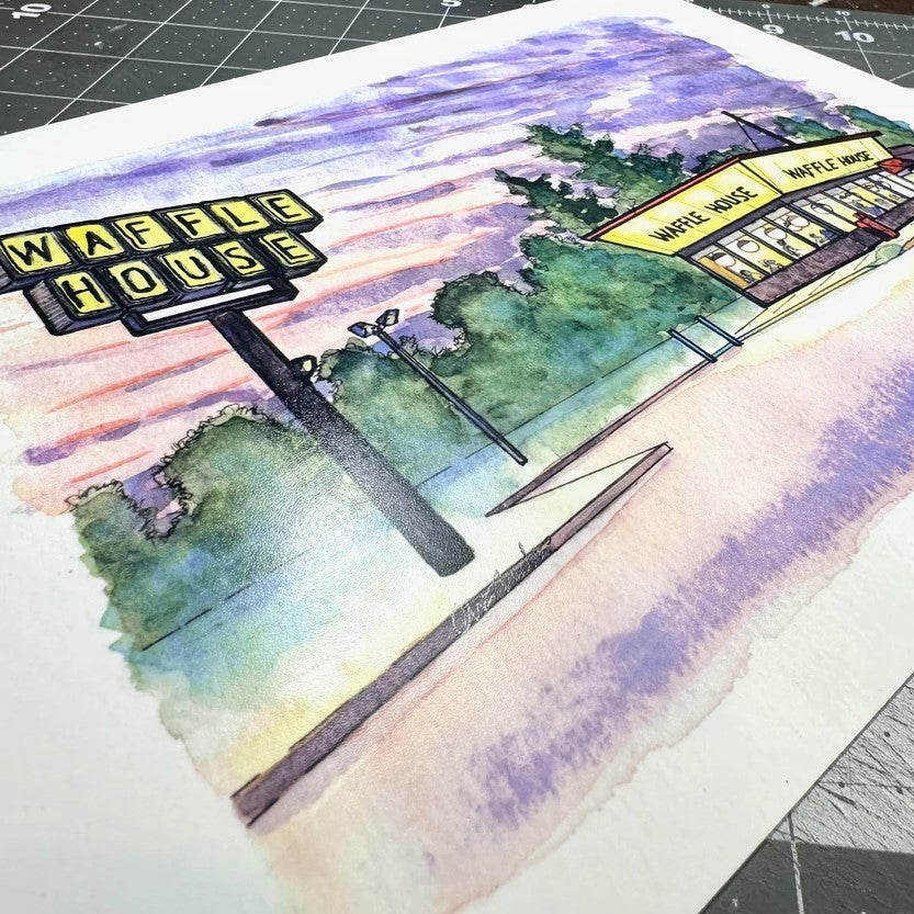 Watercolor art print depicting a Waffle House restaurant under a pale pink and blue sky