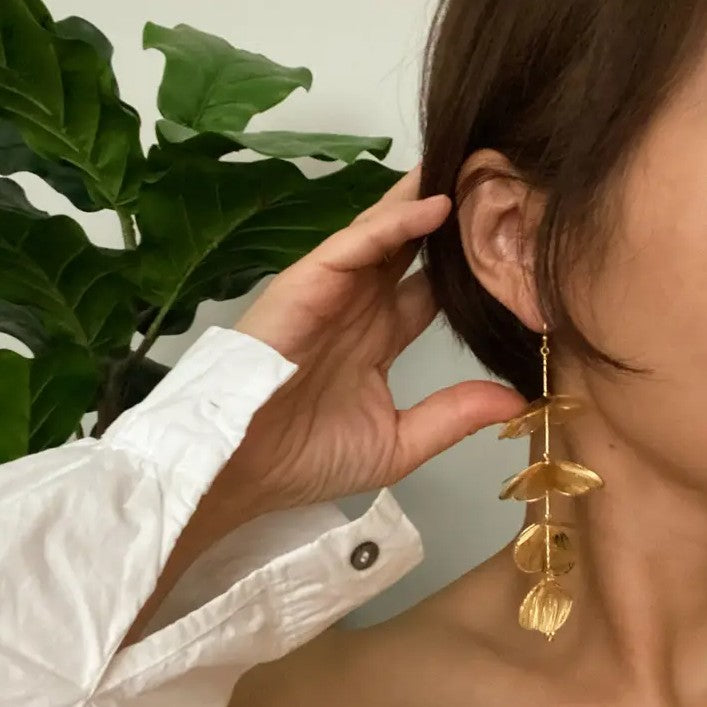 Long gold drop earrings shaped like cascading petals