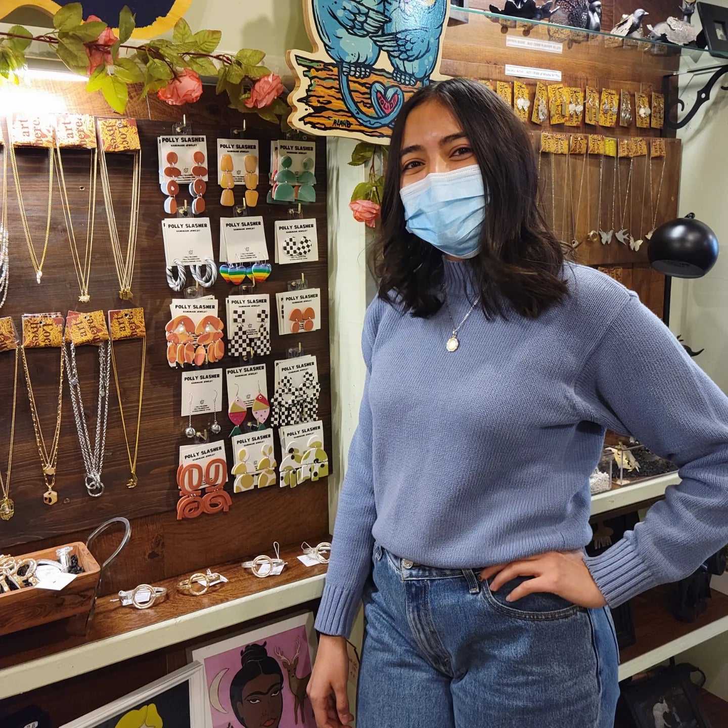 Artist Karla standing in front of her handmade jewelry inside Homegrown in Decatur, GA