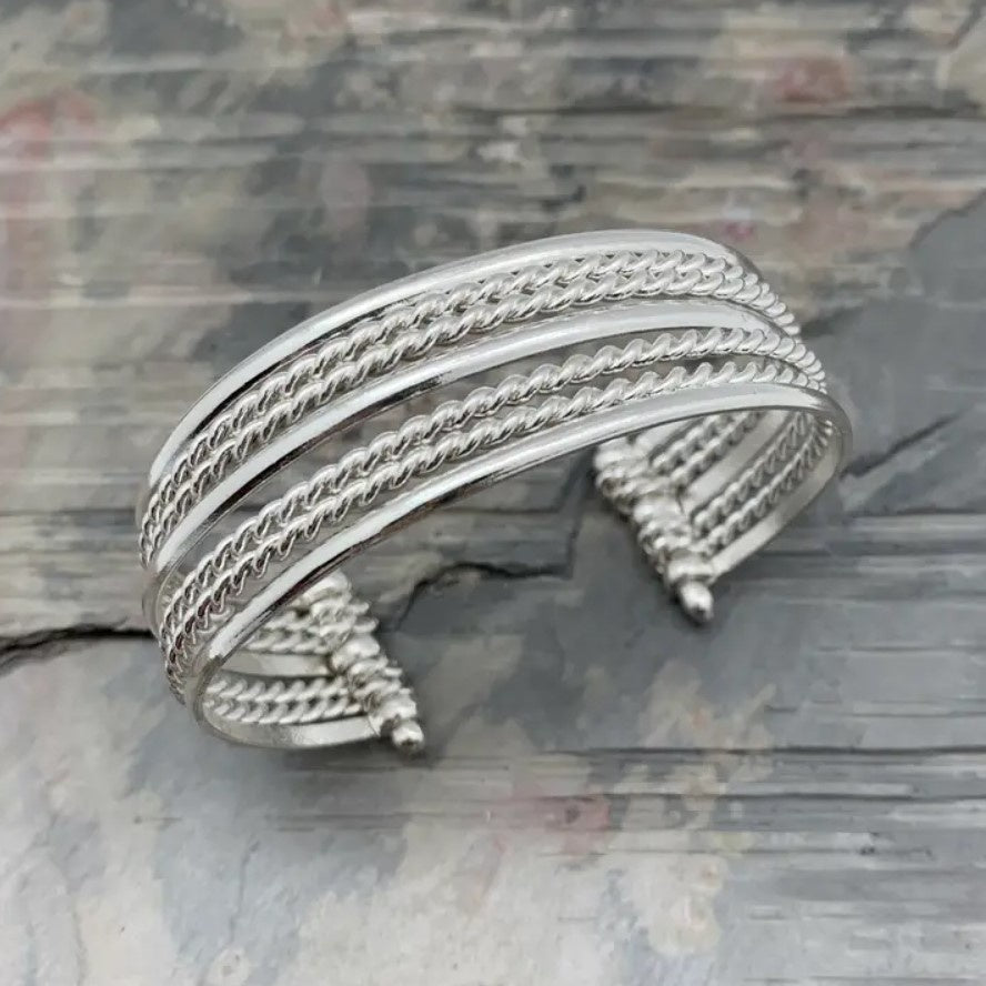 Silver cuff bracelet with mixed texture stacked bands