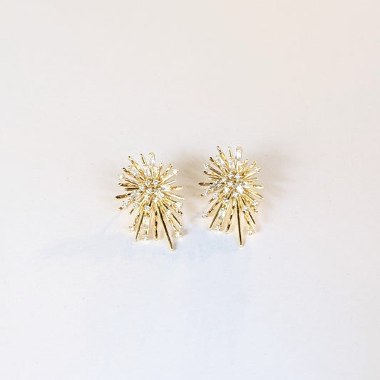 Gold spiky starburst shaped earrings decorated with small white gemstones