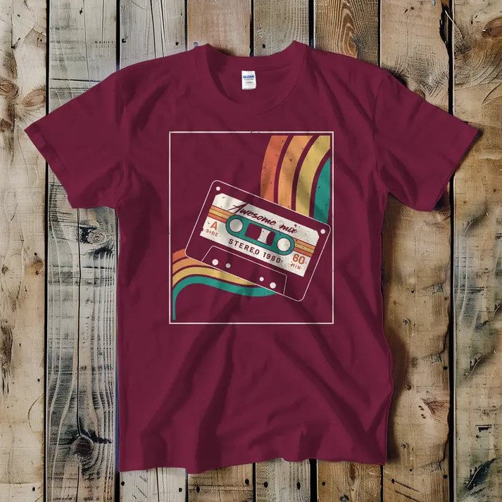 Burgundy tee shirt featuring an orange, yellow and blue illustration of a cassette tape labeled "Awesome mix, stereo 1980"