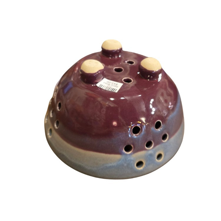 Underside of a dark purple berry bowl