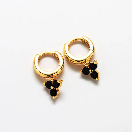 Small gold hoop earrings with three dangling black gems