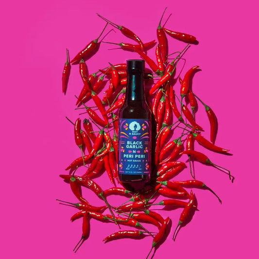 Five ounce bottle of black garlic and peri peri hot sauce, rated 4/5 spiciness.