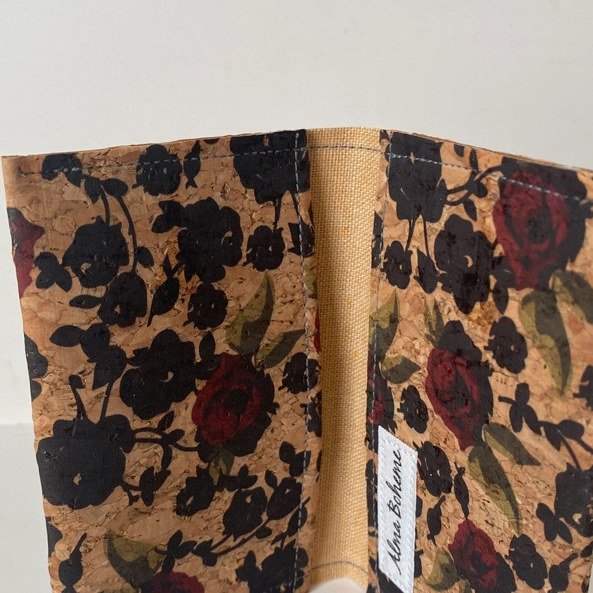 red roses and black flowers on a cork brown wallet