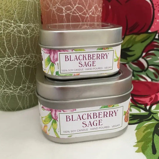 Vegan blackberry sage scented candle in a metal tin with a floral label