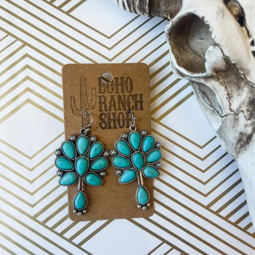 Turquoise earrings shaped like flowers with metal accents