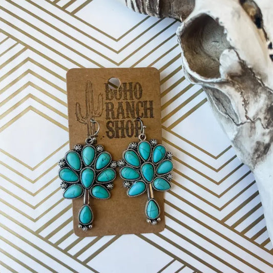 Turquoise earrings shaped like flowers with metal accents