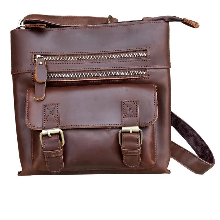 Dark brown leather crossbody bag with two zippered pockets and a buckled compartment on the front