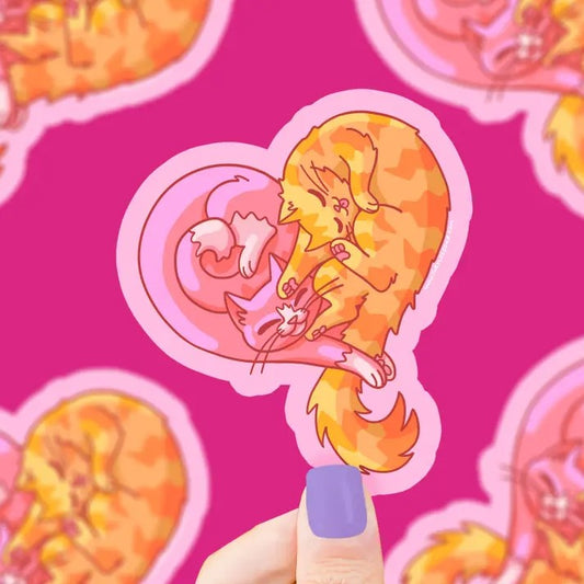 Pink heart shaped sticker of two cats entwined as they sleep