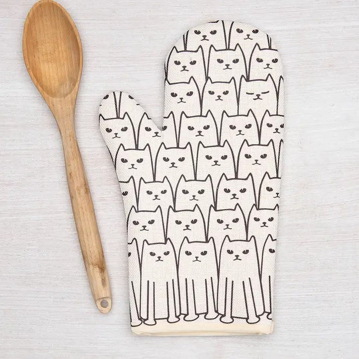 White oven mitt with a pattern of simplified cats on it