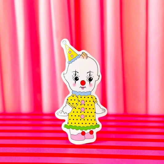 Sticker of a kewpie doll in colorful clown attire