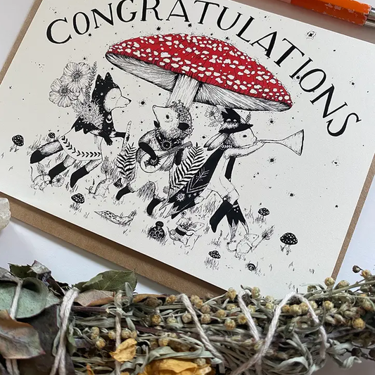 Close-up of Congratulations card featuring a large mushrom with animals playing instruments under