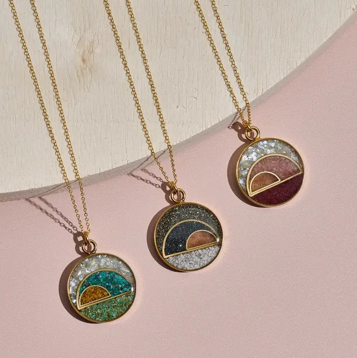 Bronze chain necklaces with round pendants featuring semi-circles of crushed gemstones in various colors