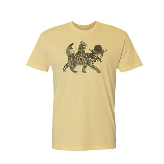 Light yellow tee shirt with an image of a cat in a cowboy hat and a rat and parakeet riding on its back