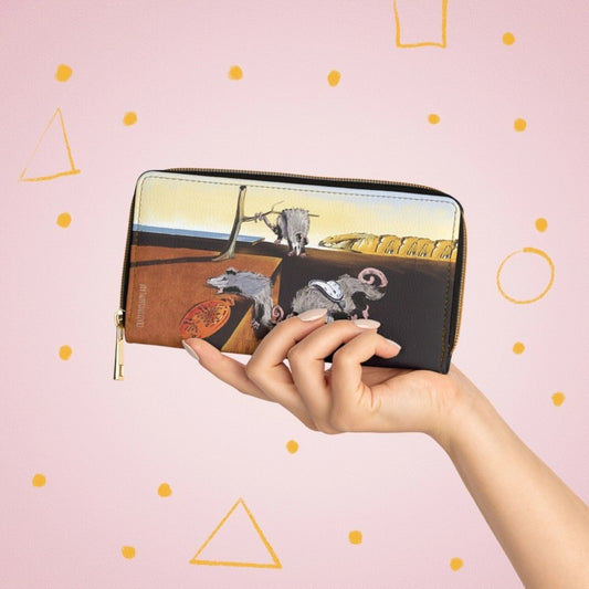Hand holding a wallet featuring a graphic of melting possums in the style of Salvador Dali