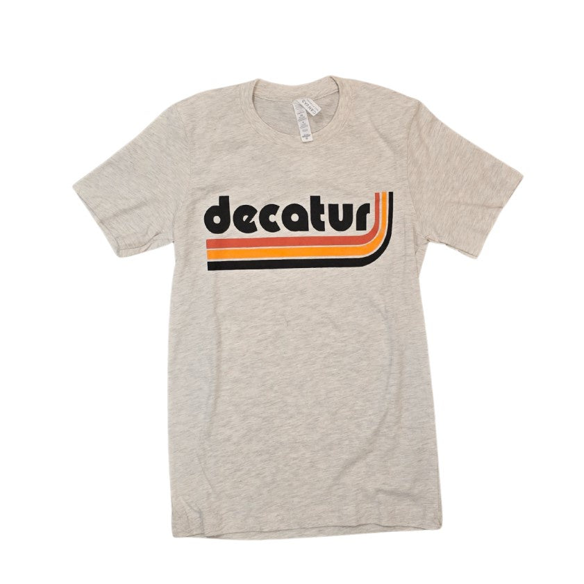 Light gray heathered tee shirt with the word "Decatur" on the front above a red, orange and black stripe swoop graphic.