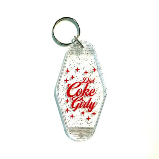 Sparkly translucent keychain with red cursive lettering that reads "Diet Coke Girly"