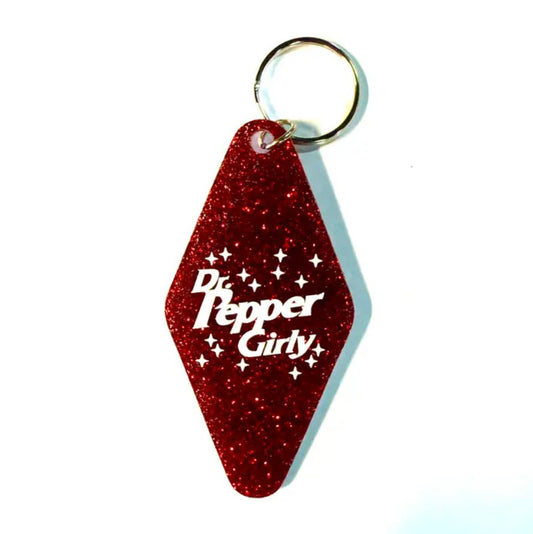 Sparkly red keychain with the words "Dr. Pepper Girly"