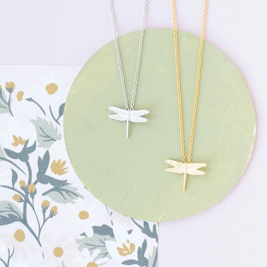 Necklace available in gold or silver featuring a small dragonfly pendant