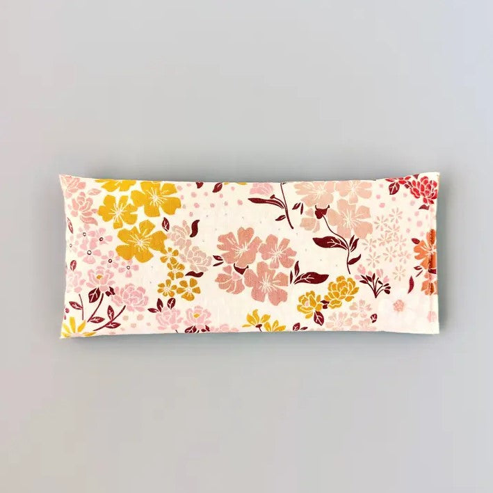 Organic lavender and flaxseed eye pillow in a pink, yellow and orange floral pattern