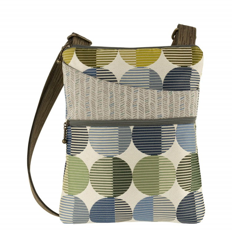 Purse with a shoulder strap and zippered front compartment. It is in a circular beige, blue and green geometric pattern