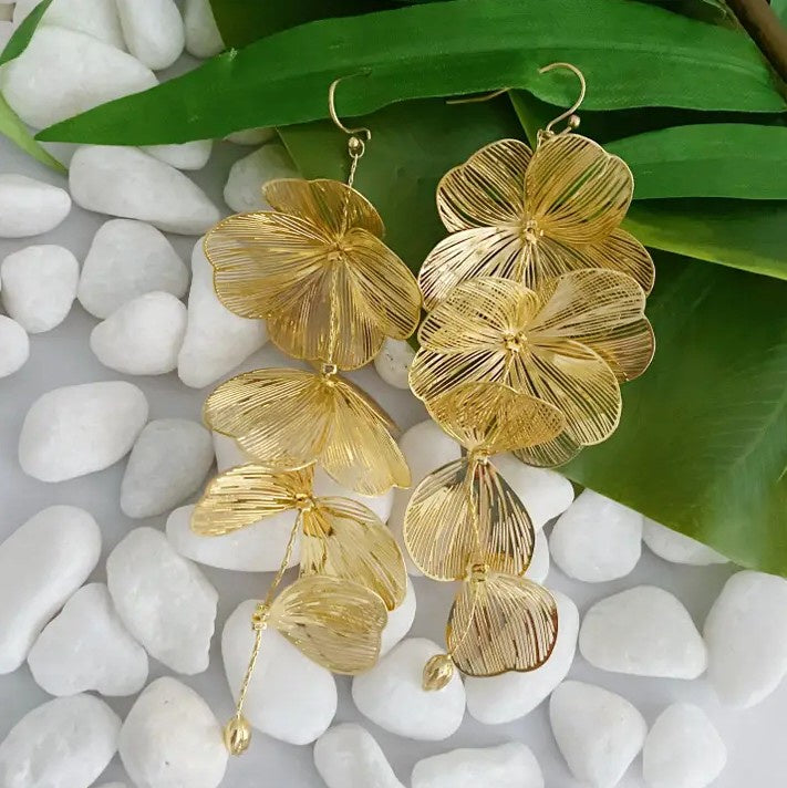 Long gold drop earrings shaped like cascading petals