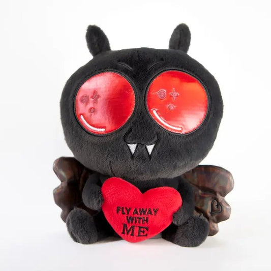 Black plush toy shaped like Mothman holding a heart that reads "Fly away with me"