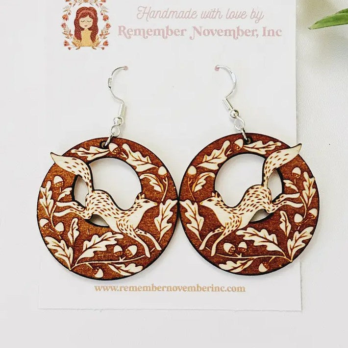 Circular wooden earrings with engraved foxes and leaves