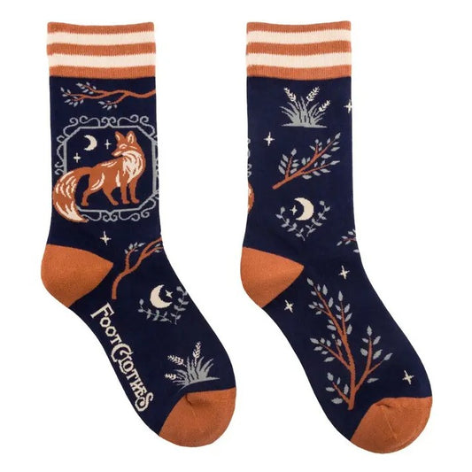 Navy blue socks with a pattern featuring tree branches, moons and foxes