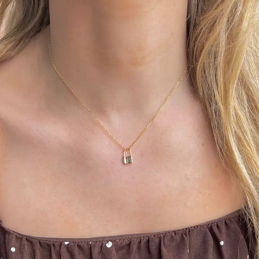 Gold necklace with small gold lock-shaped charm