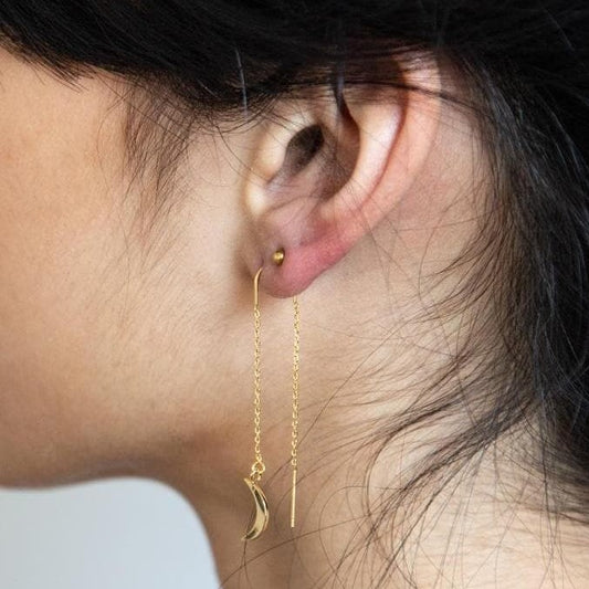 Dangling chain gold earrings with a crescent shaped charm