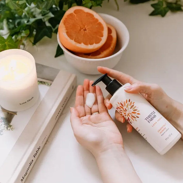 Grapefruit jasmine scented hand lotion in a pump bottle with the slogan "Love Heals"