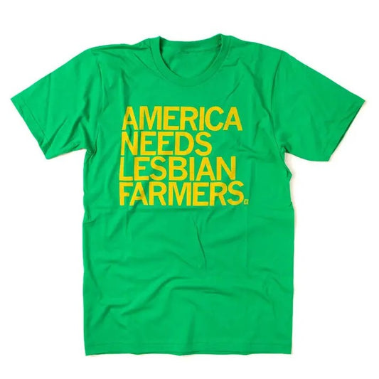 Green tee shirt with bright yellow text that reads "America Needs Lesbian Farmers."