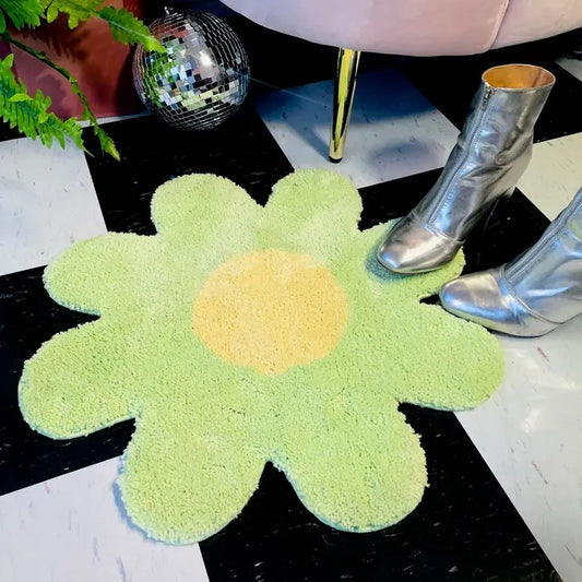 green daisy flower rug with silver shoes and disco ball props around it