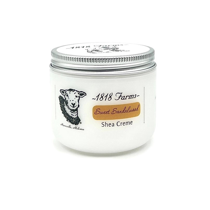 Sandalwood Shea Creme inside a white tin with medal lid