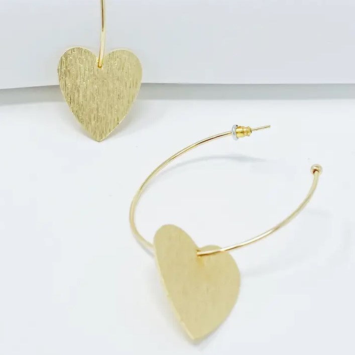 Gold hoop earrings with brushed gold dangling hearts