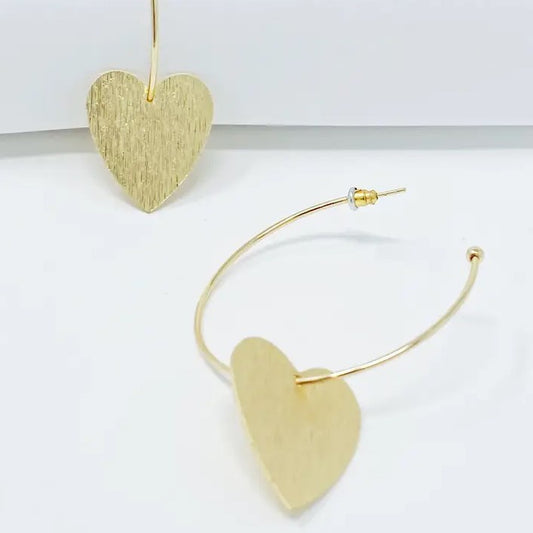Gold hoop earrings with brushed gold dangling hearts