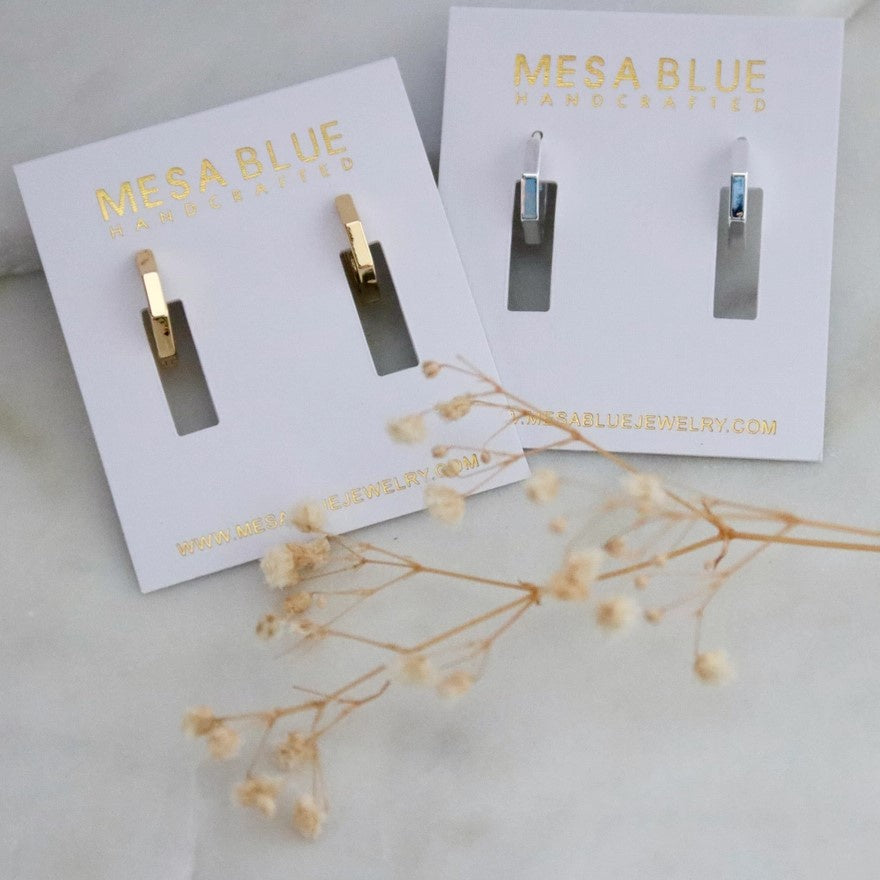 Two pairs of small hexagonal hoop earrings available in silver or gold