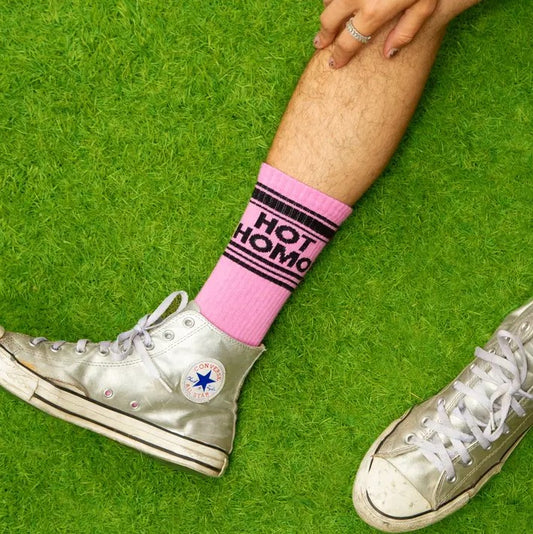 Light pink calf socks with the words "Hot Homo" in black at the top.