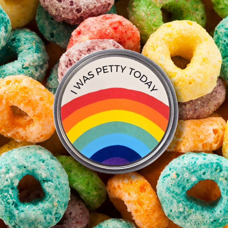 Candle with a rainbow label that reads "I was petty today" on the lid