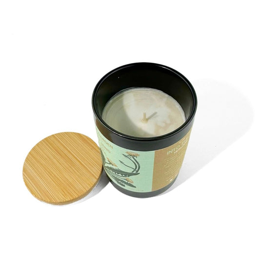 Candle in a black jar with a wooden lid