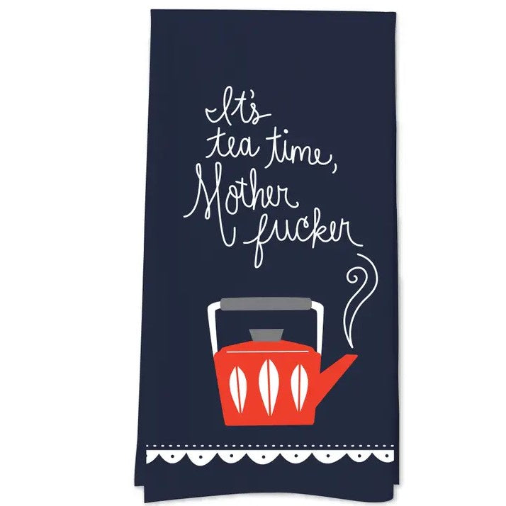Navy blue tea towel with a red kettle on it and the words "it's tea time, mother fucker" in a loopy cursive font