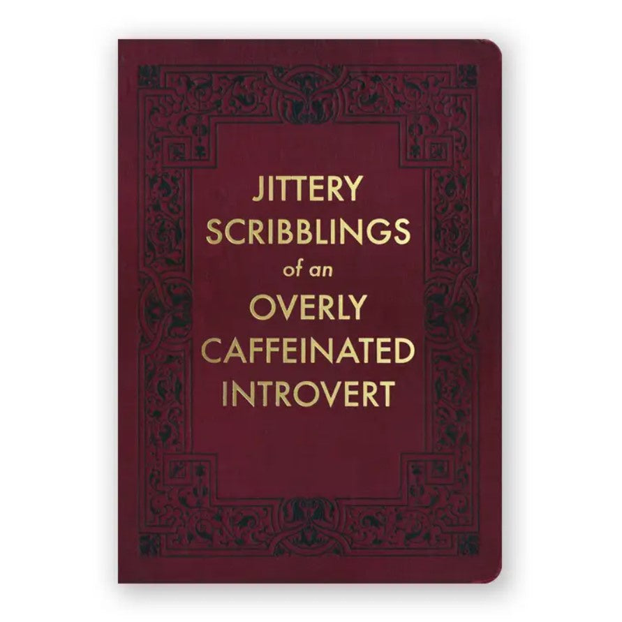Burgundy journal with black ornate detailing and gold lettering that reads "Jittery scribblings of an overly caffeinated introvert"