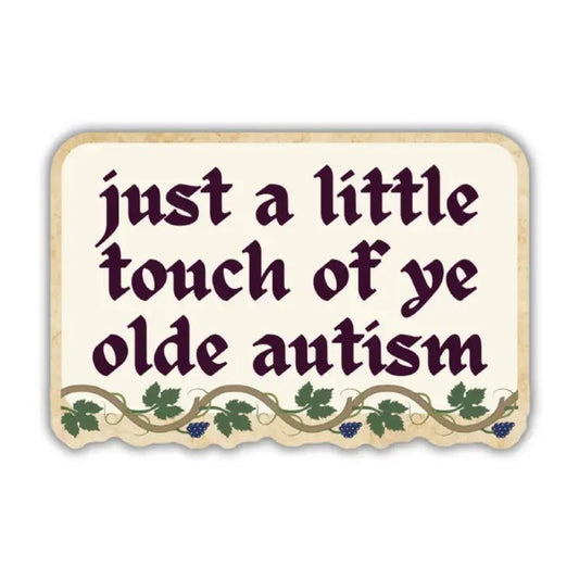 Cream colored vinyl sticker with a grapevine border reading "just a little touch of ye olde autism"