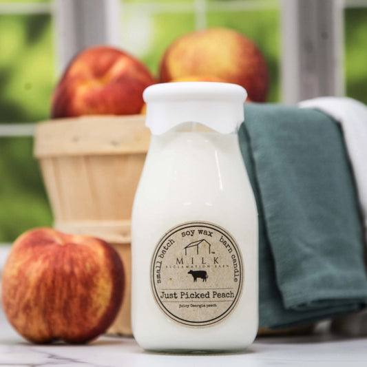 Soy wax candle shaped like an old fashioned milk bottle in the scent "Just Picked Peach"