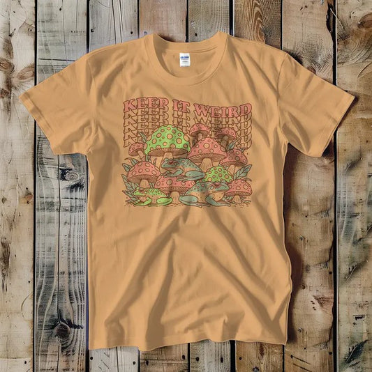 Beige t-shirt with an illustration of pink, green and blue frogs underneath trippy layered text that reads "Keep it weird"
